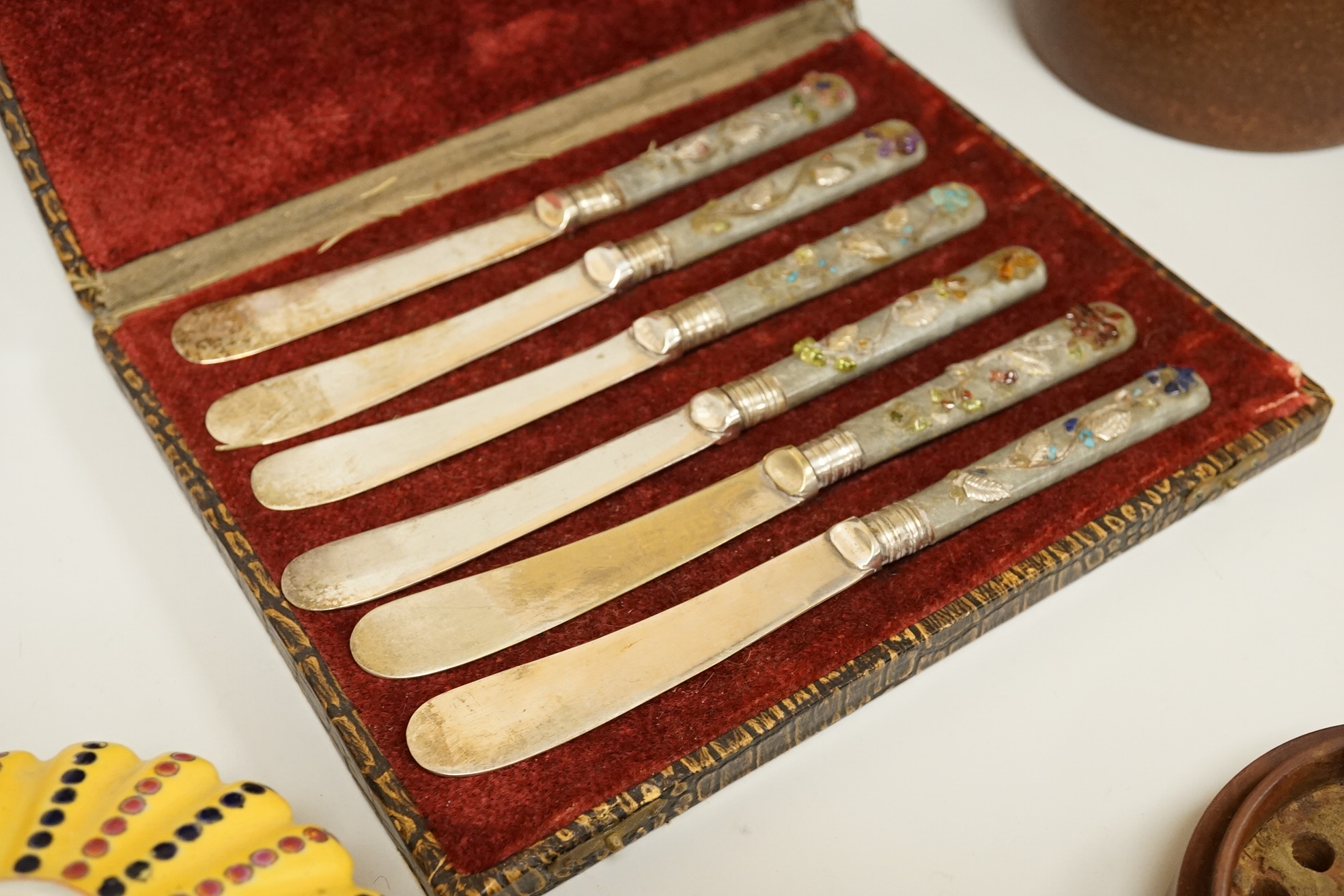 A cased set of semi-precious handled butter knives, two Chinese pottery teapots, a stoneware box and a figure, etc.